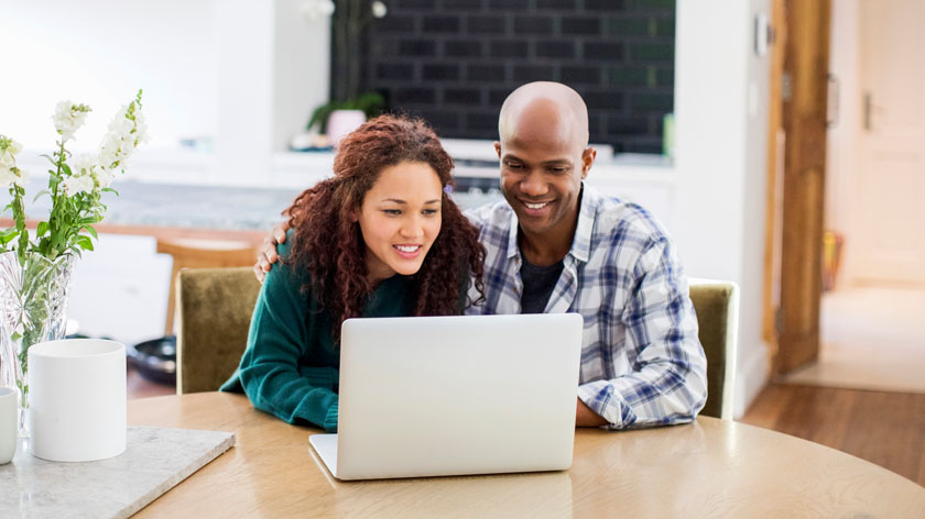 couple reviewing investments on their laptop